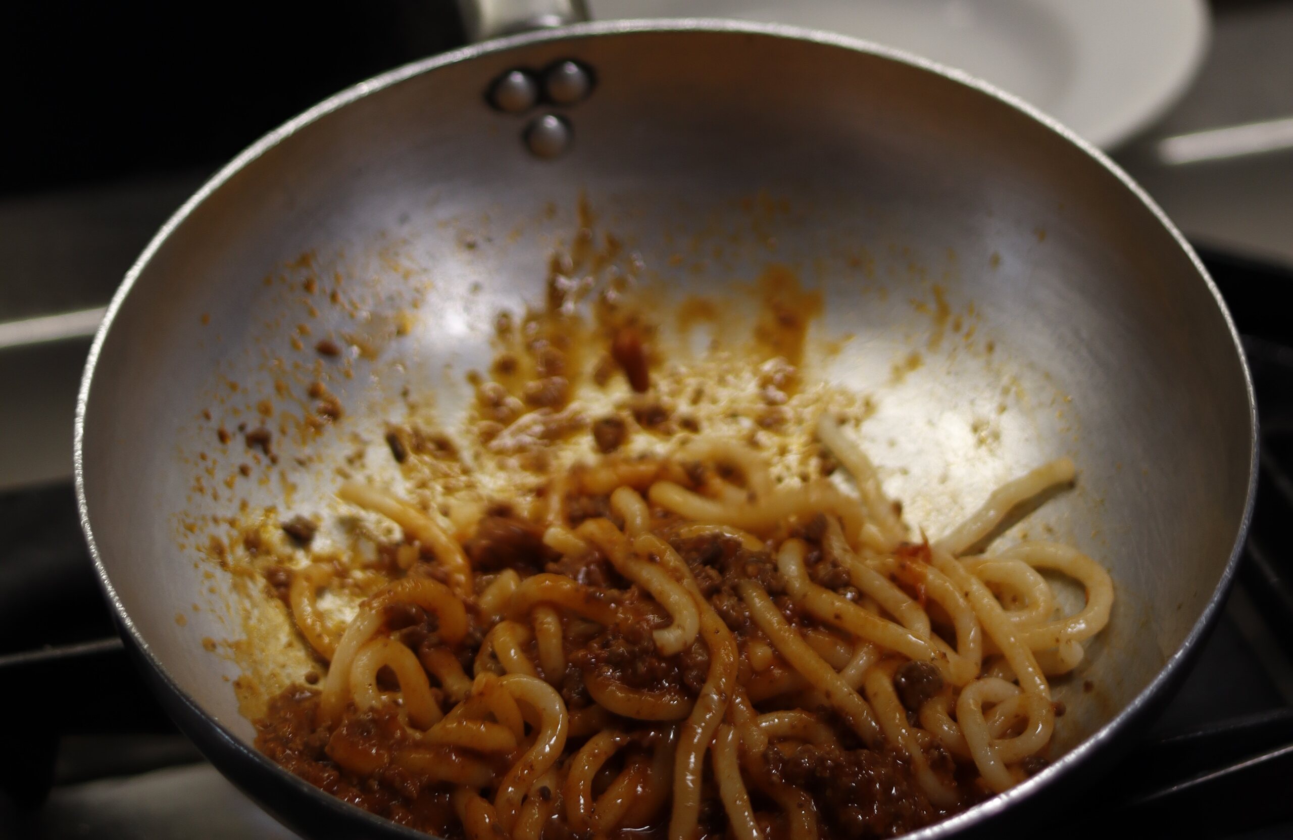 Fresh pasta being tossed in a pan in the Il Cantuccio kitchen