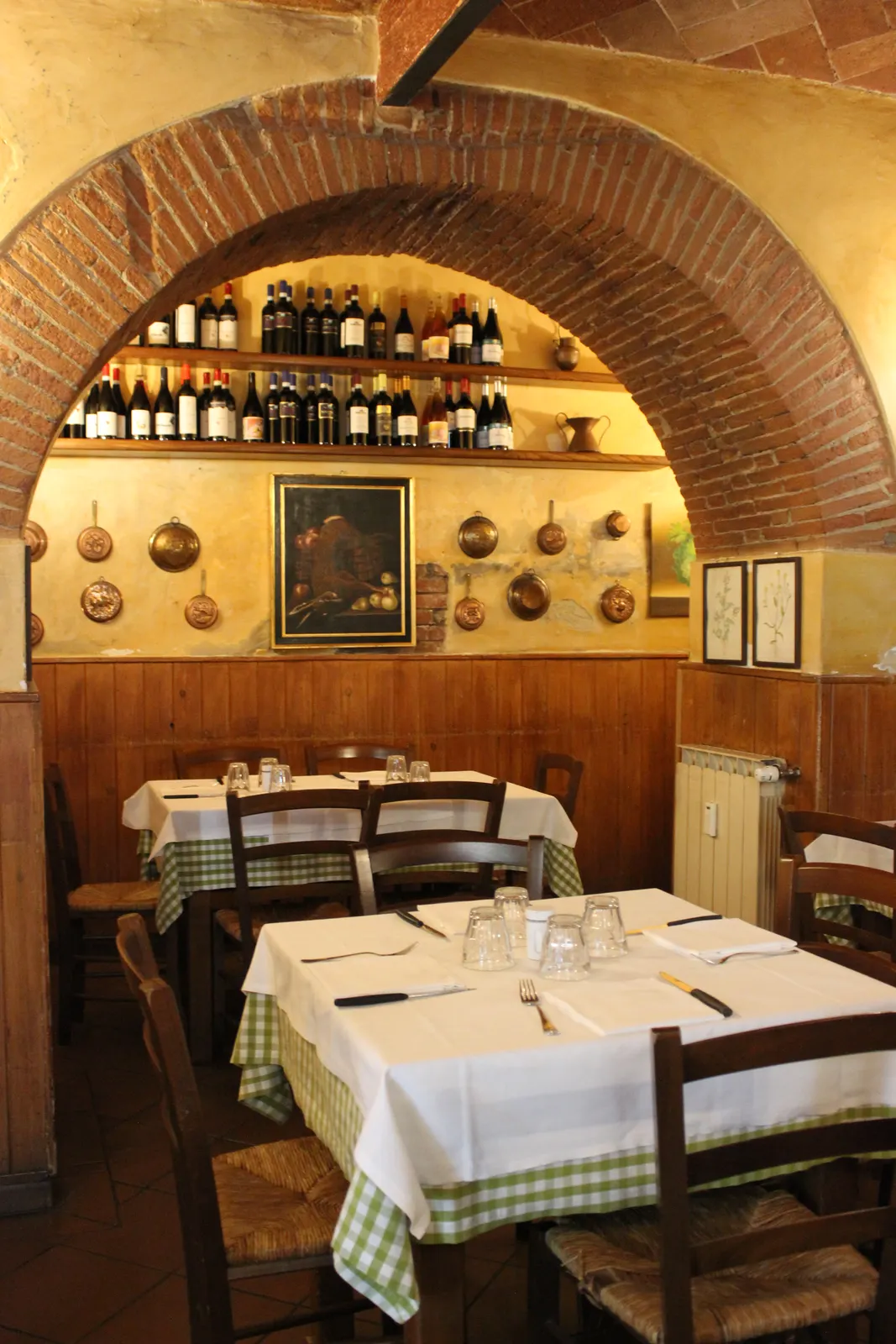 Tables set beneath the brick vaults